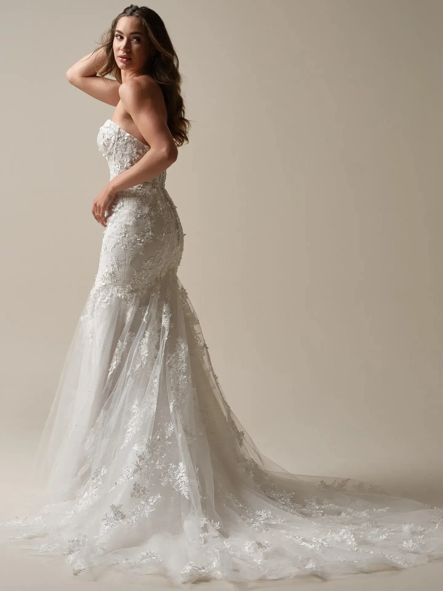 Model is wearing a 3D floral lace fit and flare wedding dress by maggie sottero