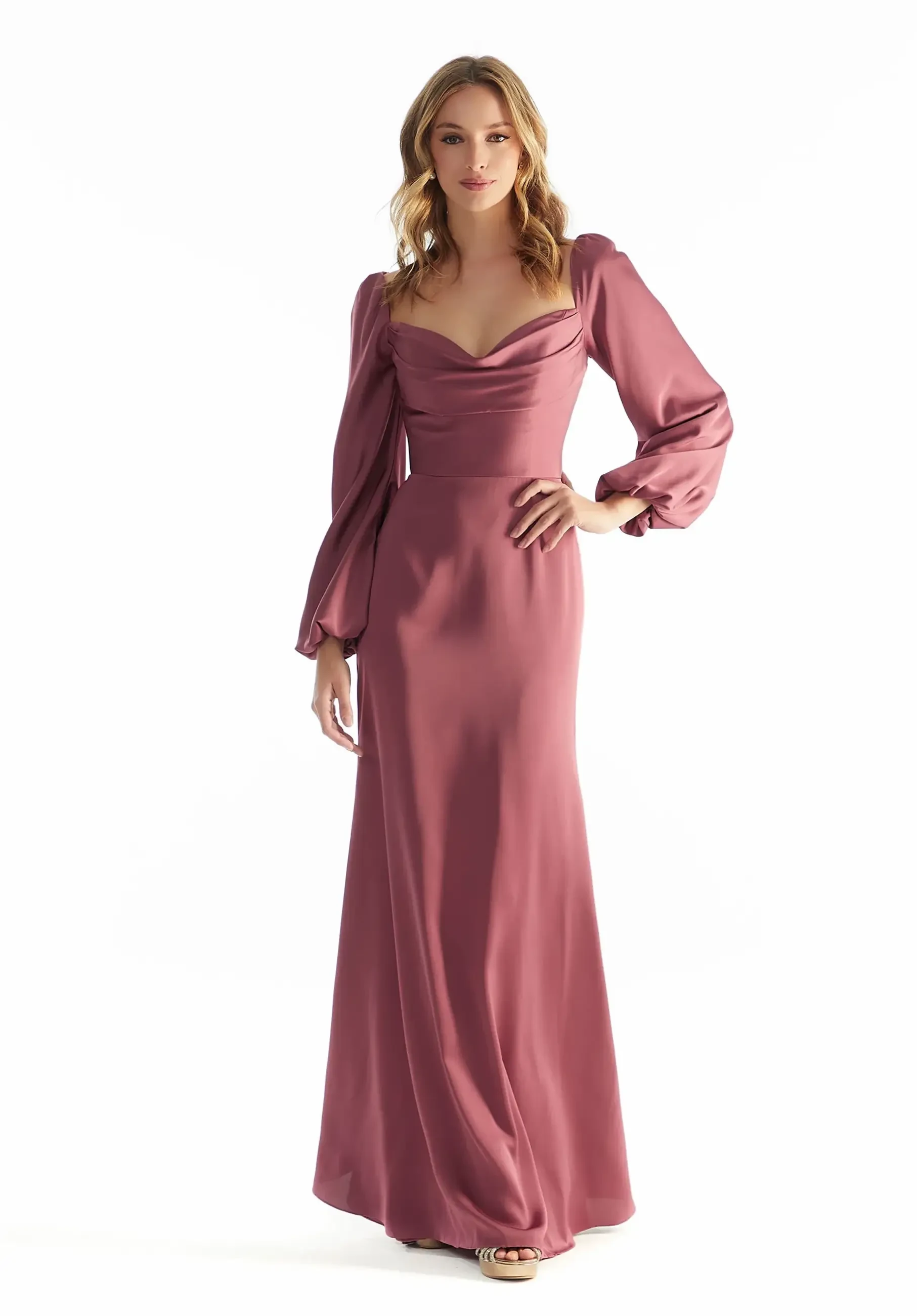 Model is wearing a satin A-line bridesmaid dress with a corset bodice, cowl neckline, bishop sleeves, and a strappy open back.