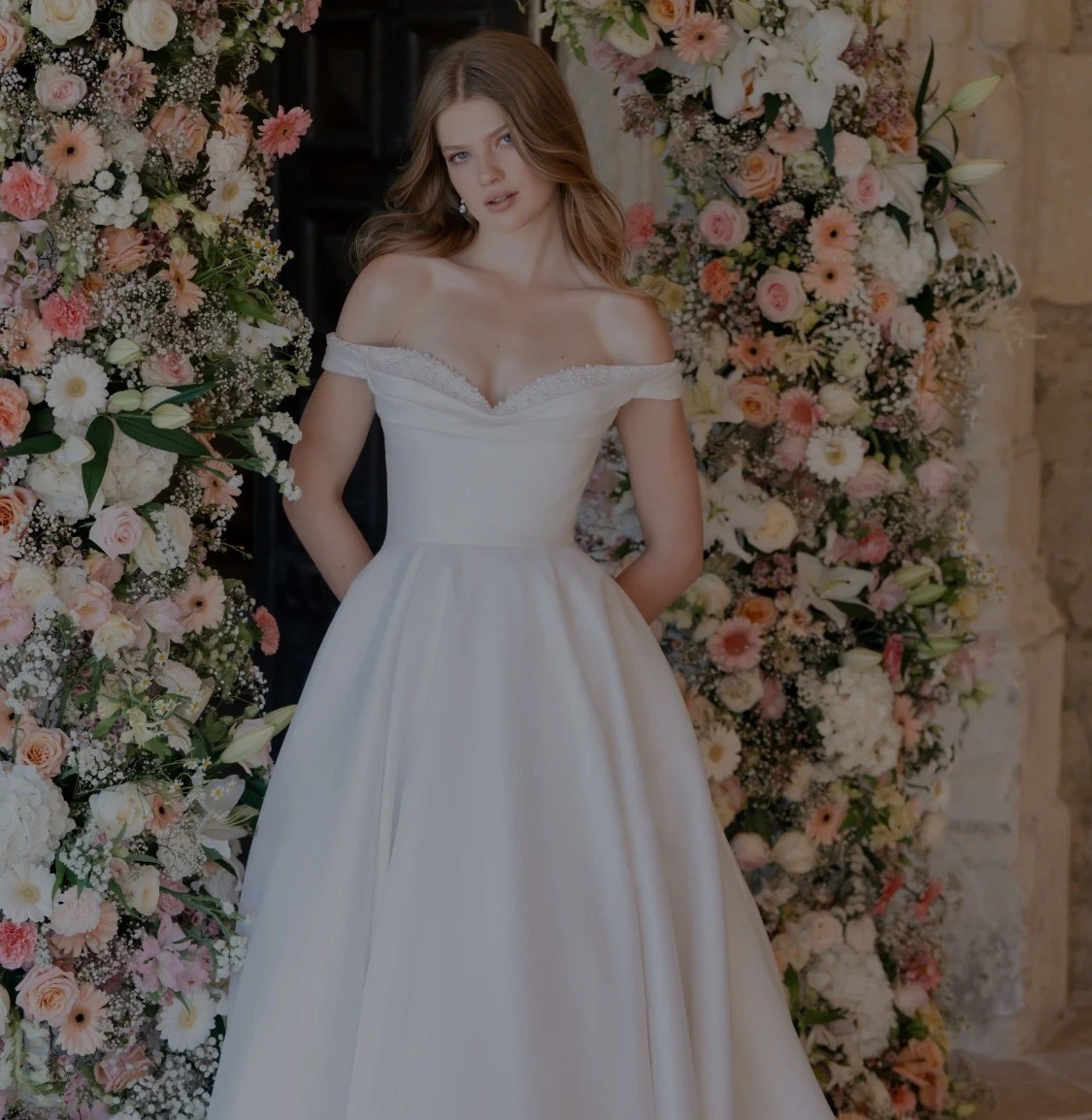 Model wearing white gowns from different bridal collections