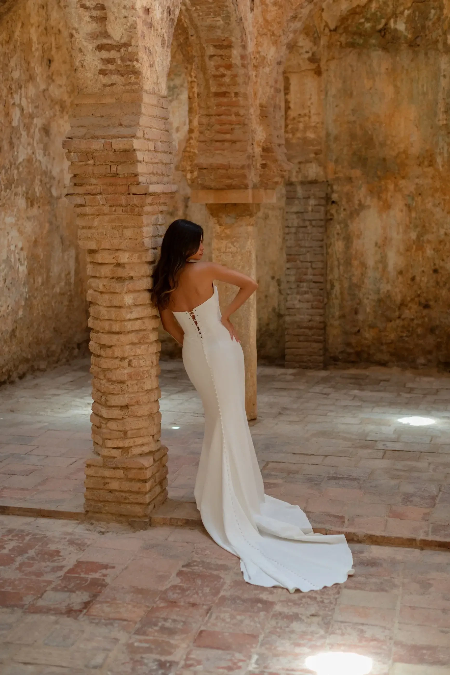 Model is wearing a crepe sheath wedding dress by wilderly bride