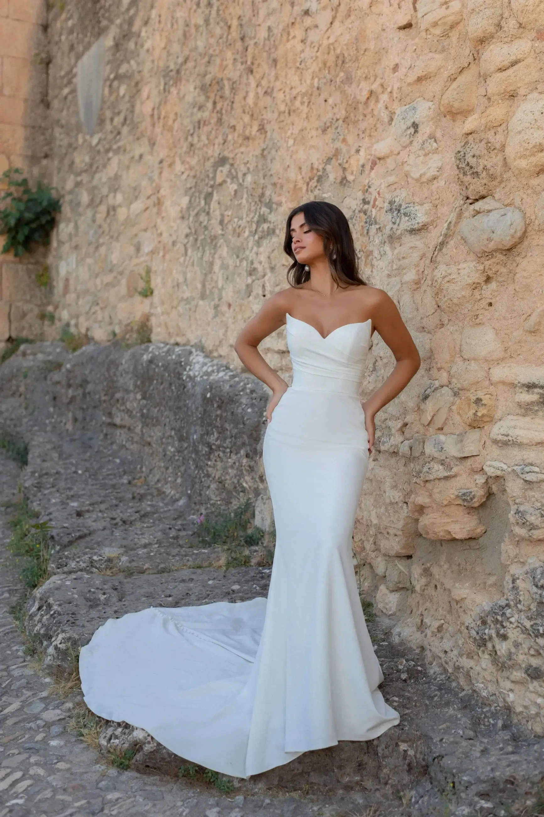 Model is wearing a crepe sheath wedding dress by wilderly bride